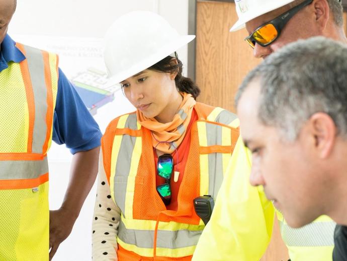 Female Keller project manager talking with colleagues